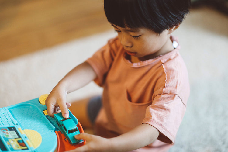 Kid Boy Playing with his toys