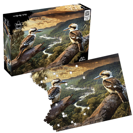 Puzzle Master Kooka Brothers jigsaw puzzle box shown above a partially assembled puzzle featuring two kookaburras on branches overlooking a valley.