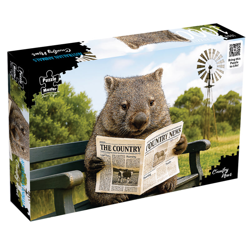 Load image into Gallery viewer, Puzzle box for Puzzle Master Australian Animals Country News jigsaw puzzle showing a wombat reading a newspaper on a bench.
